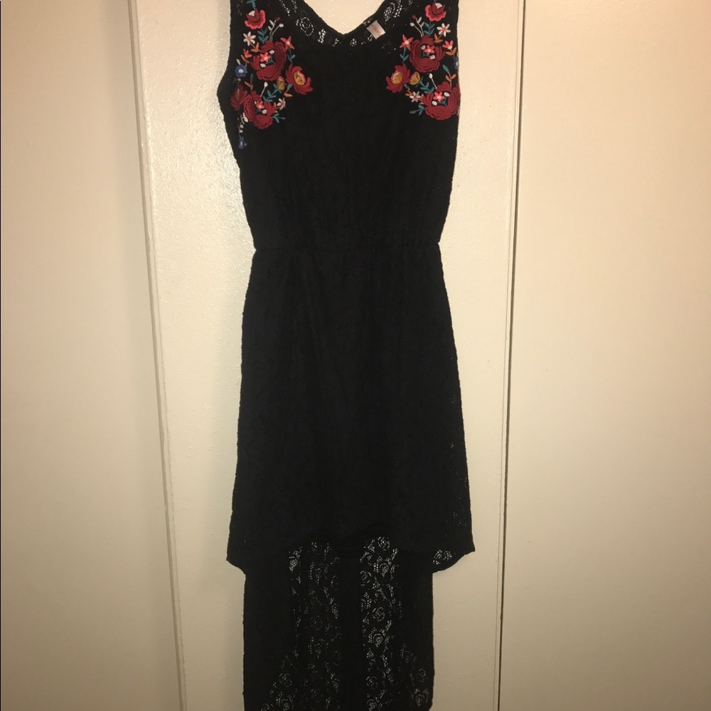 High low black lace dress with accent flowers.