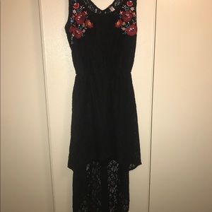 High low black lace dress with accent flowers.
