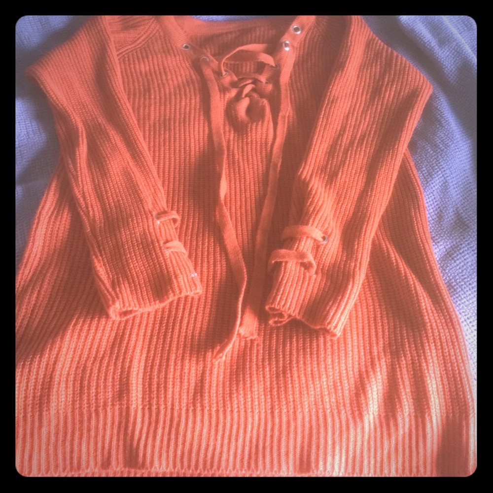 Long burnt orange sweater-like shirt.