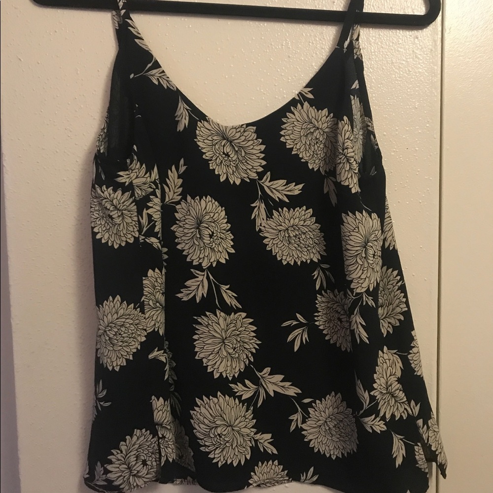 Flowy black tank top with a white floral design