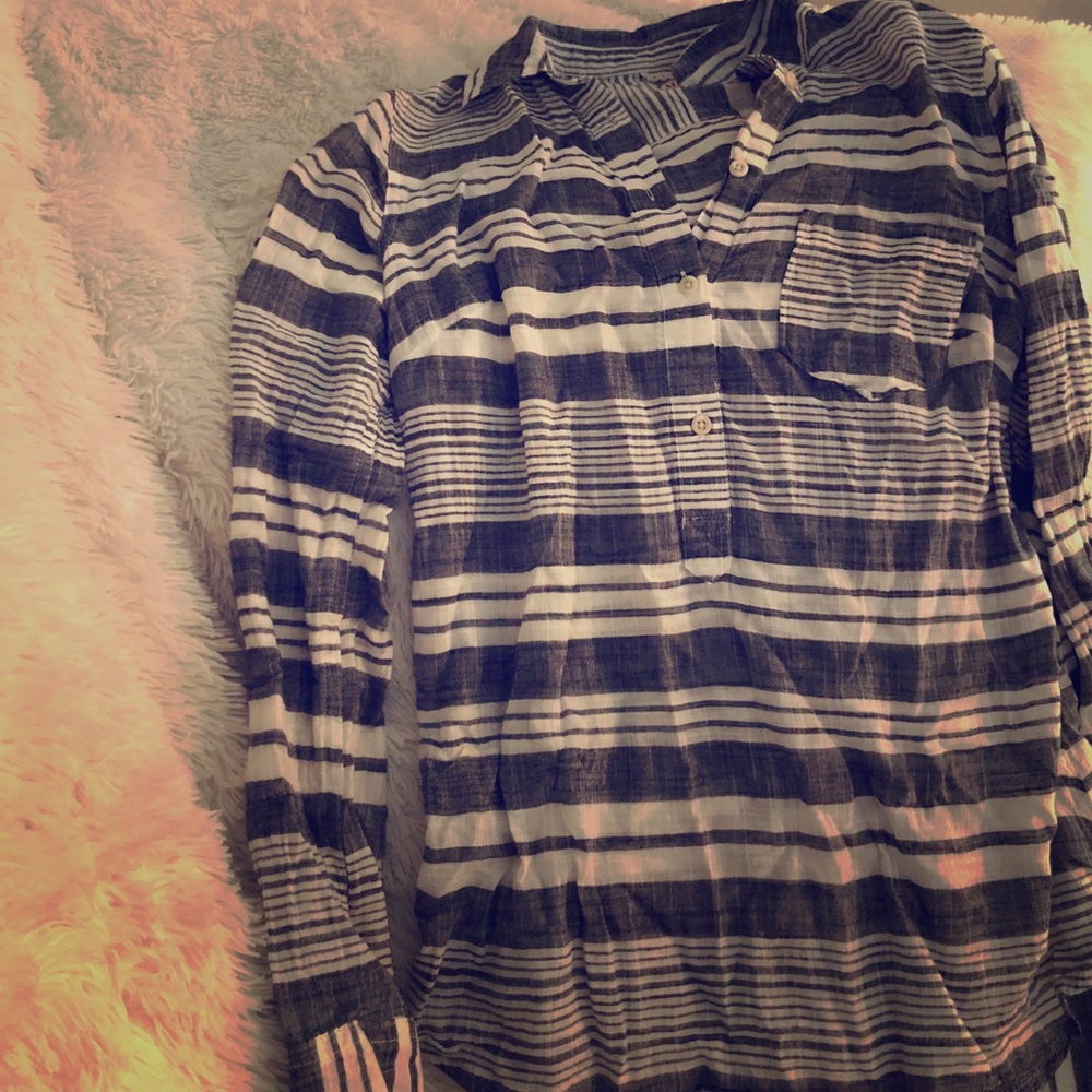 Long sleeved striped halfway button down shirt.