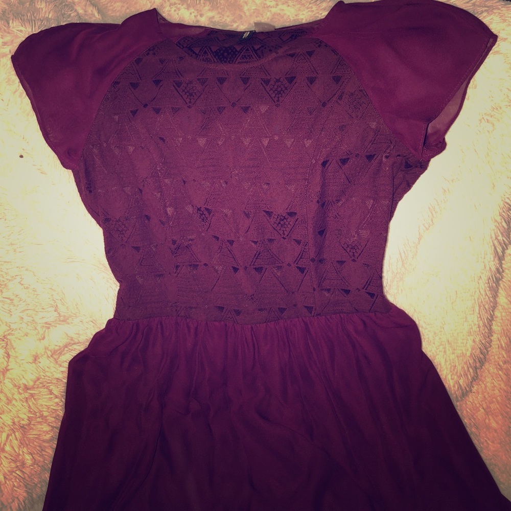 Plum short sleeved thigh length dress.