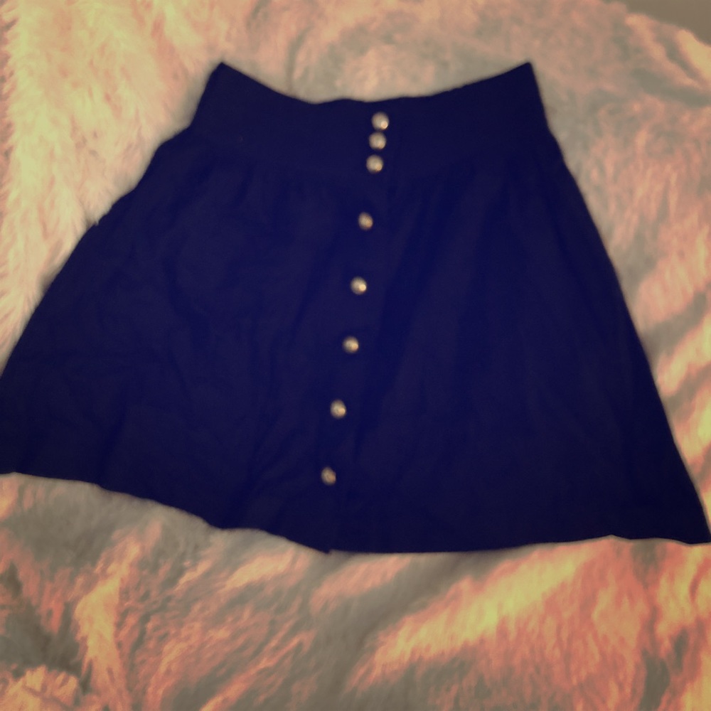Black mini skirt with gold buttons.