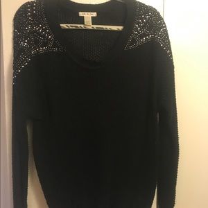 Black sweater with embellishment on the shoulders