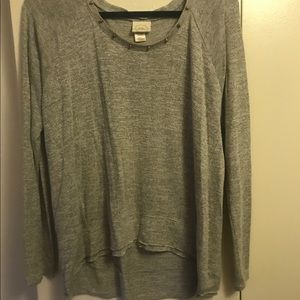 Gray sweater with gold studs around the neck