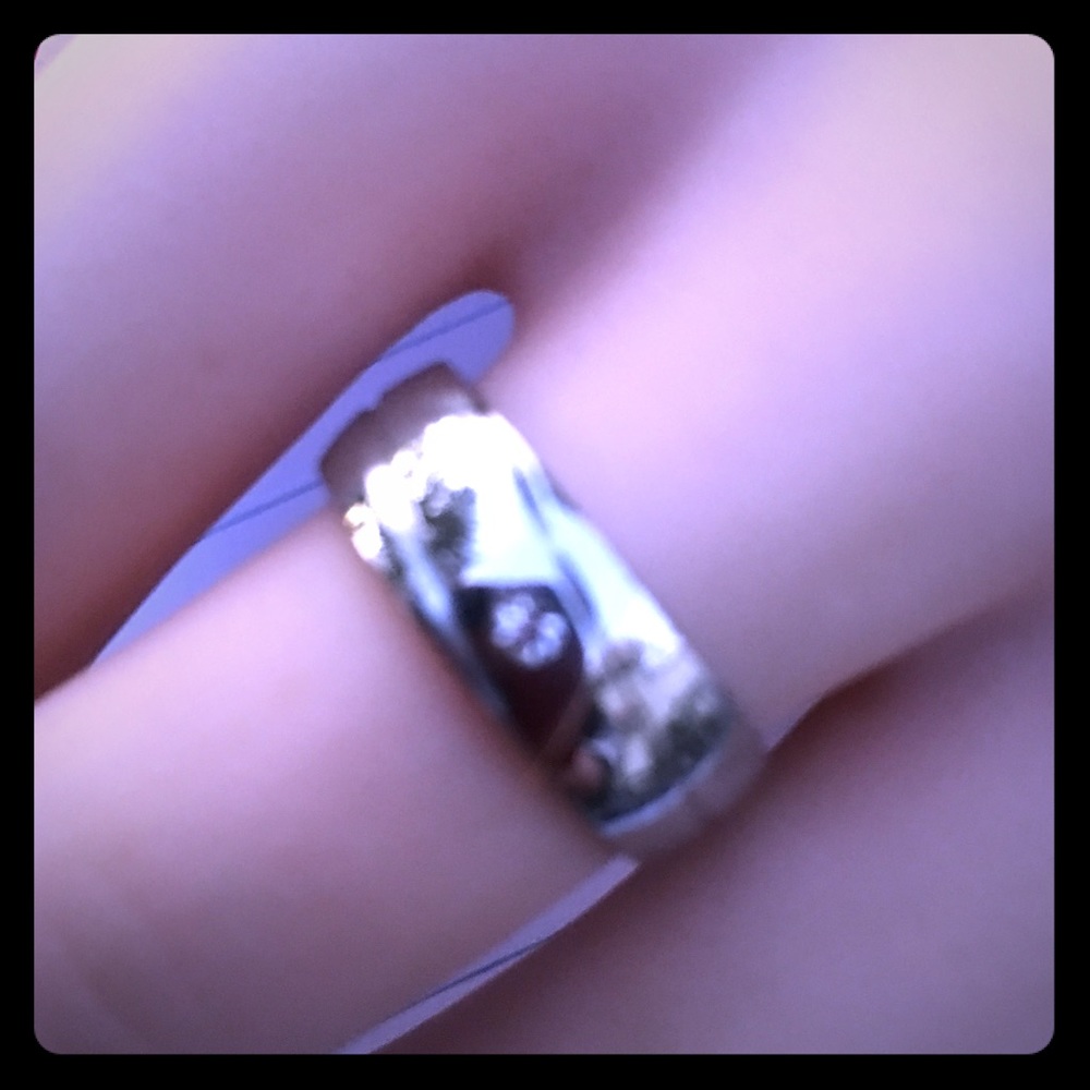 Silver/ stainless with one cubic zirconia ring.