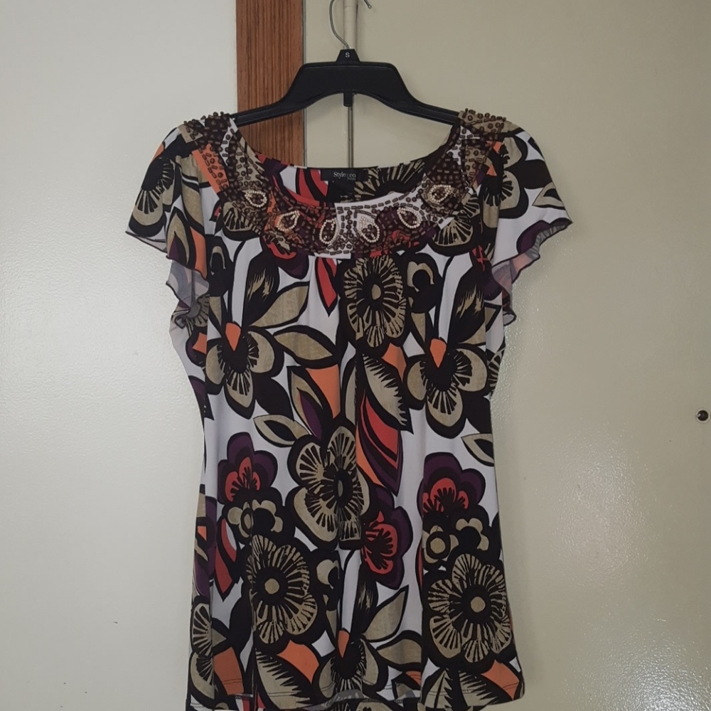 Floral print blouse with beading.