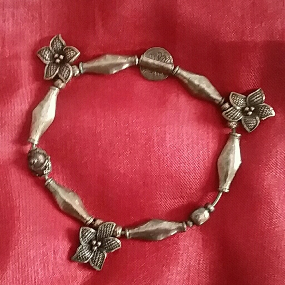 A metal stretchy bronze colored charm bracelet