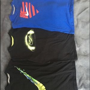 Three Nike Boys' t shirts 2 blue one black.