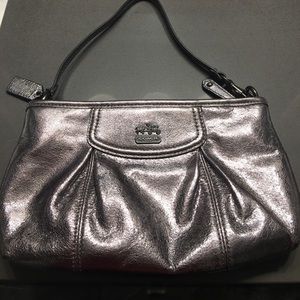 Metallic coach wristlet clutch