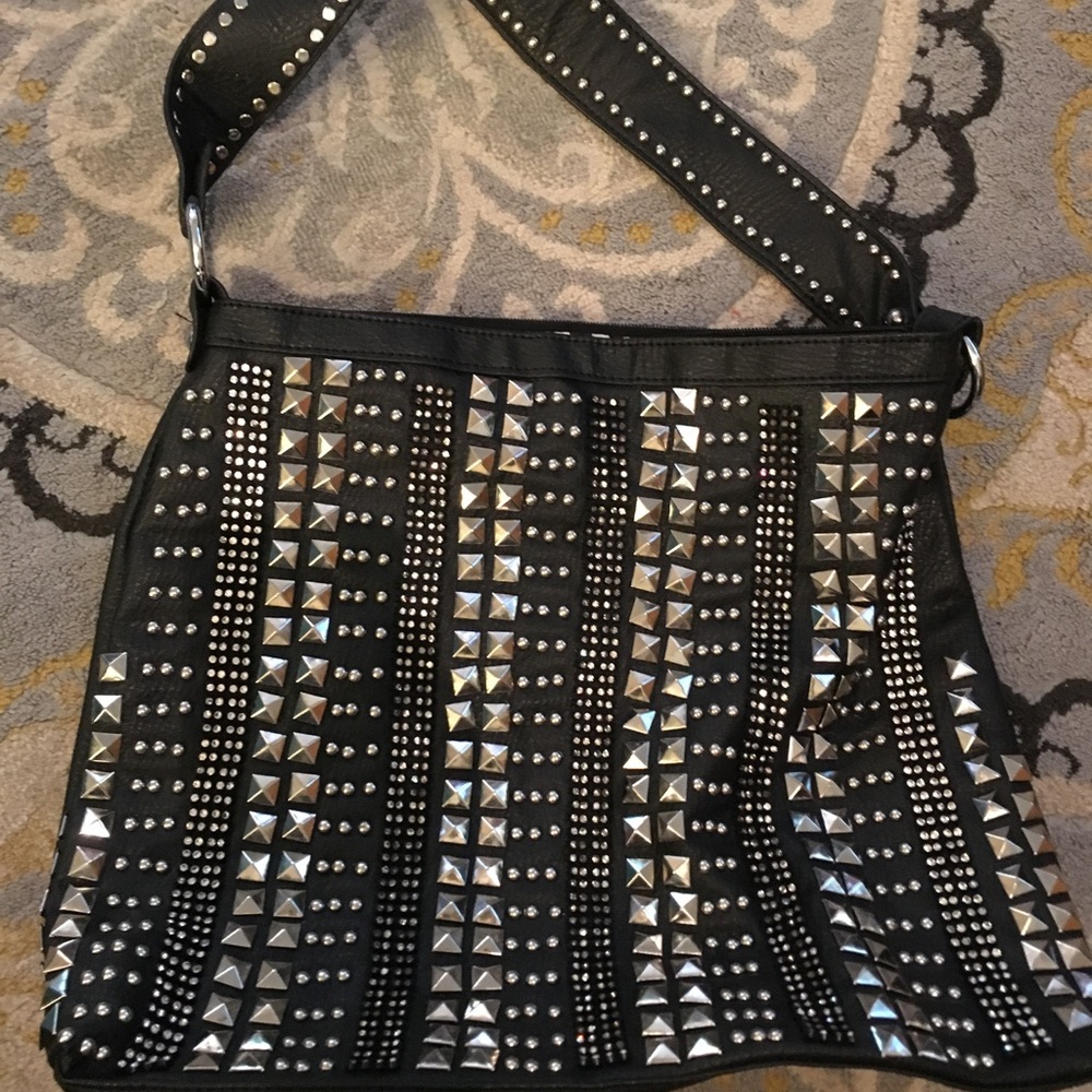 Beautiful studded black tote w/ Zebra lining.