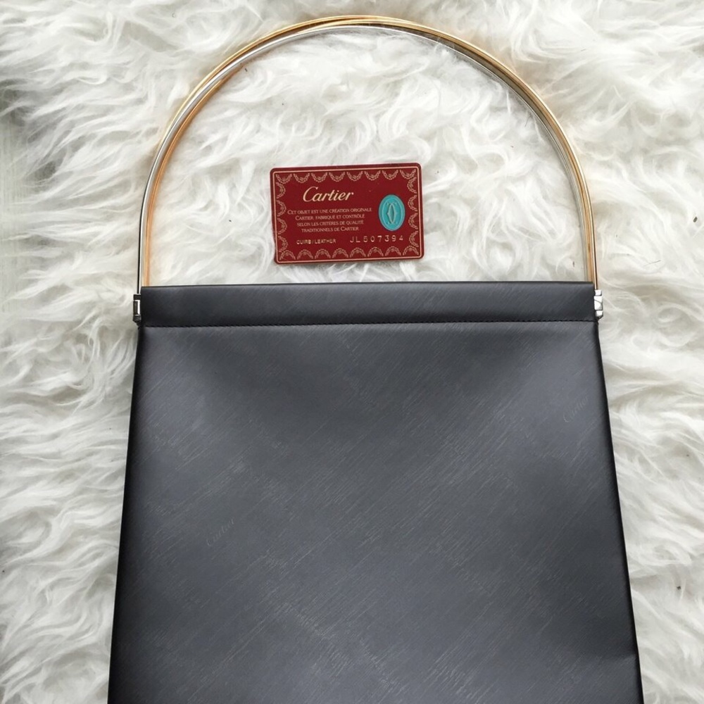 CARTIER leather bag with red suede inside.