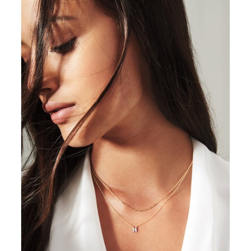 COVET by Stella & Dot yellow gold “L” necklace.