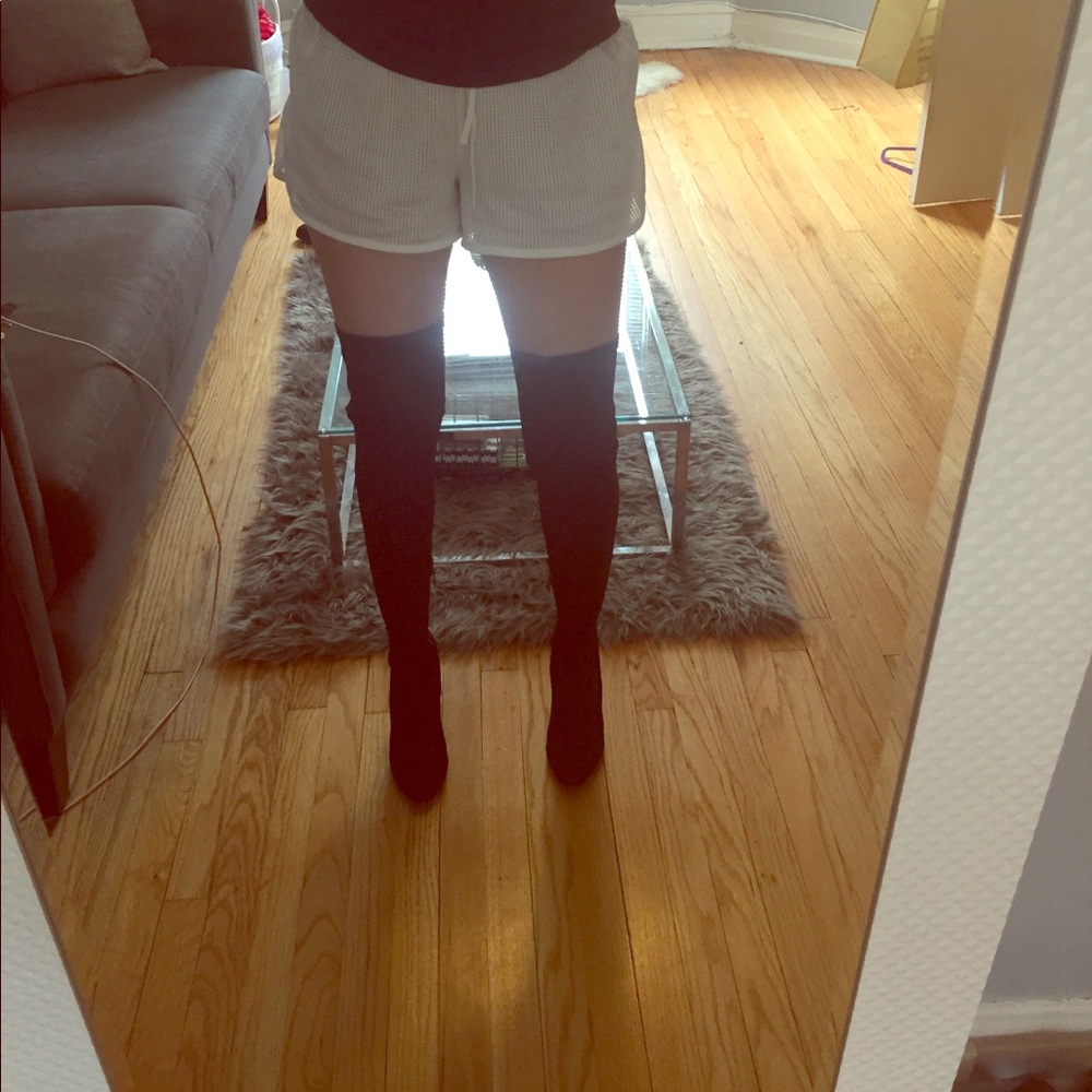 Thigh high, form fitting black boots
