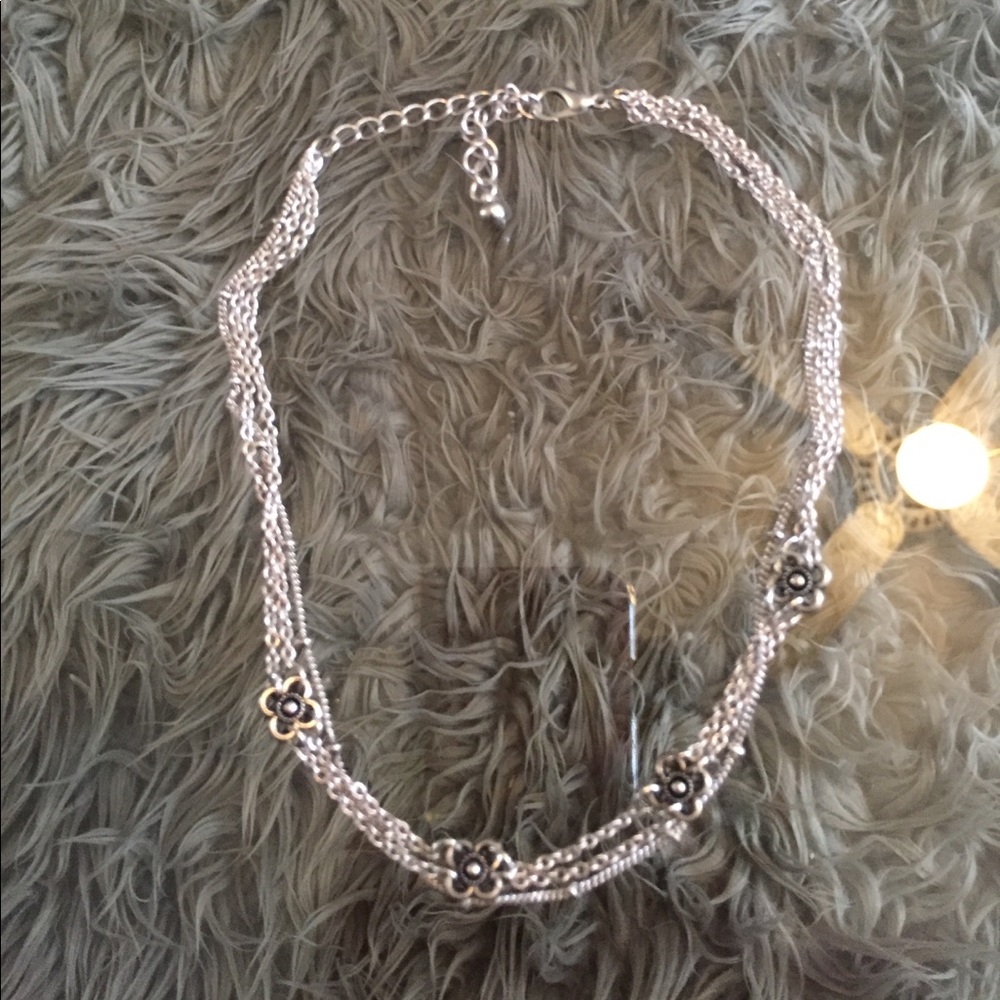 Silver choker with flowers.