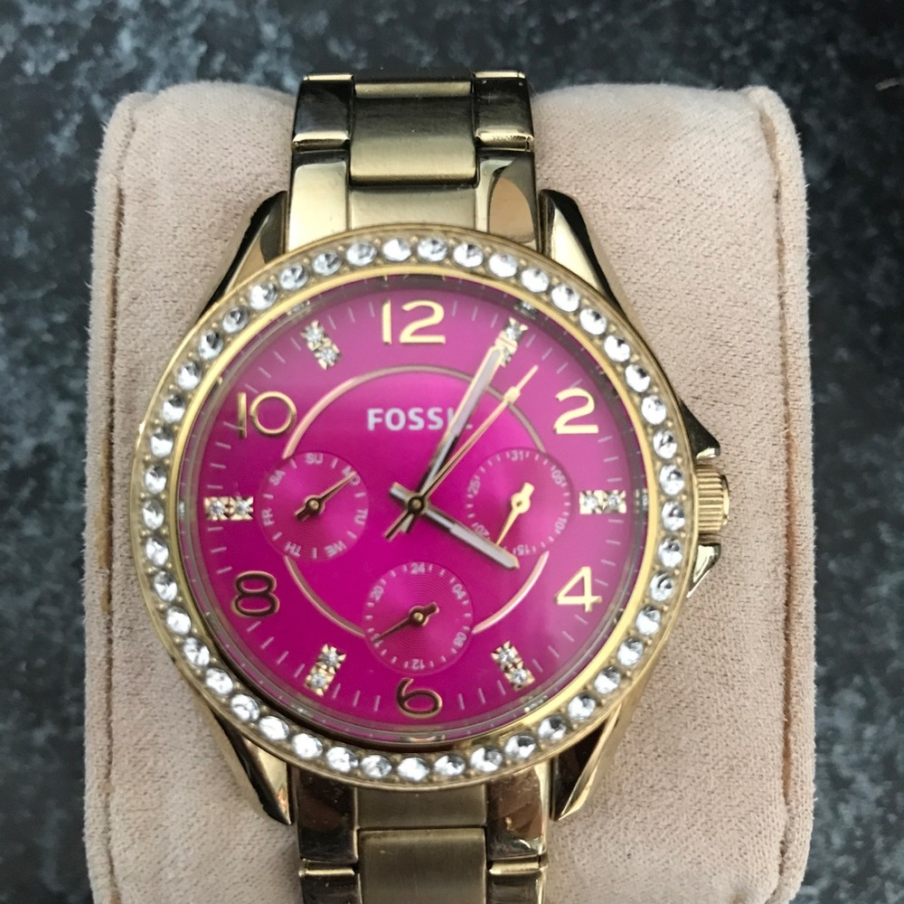 Fossil Women's watch gold tone with pink face.