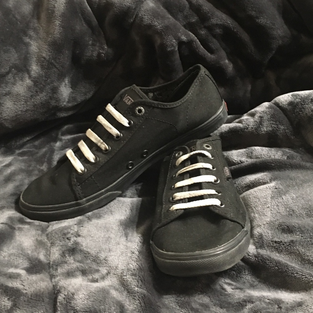 All black low top Vans