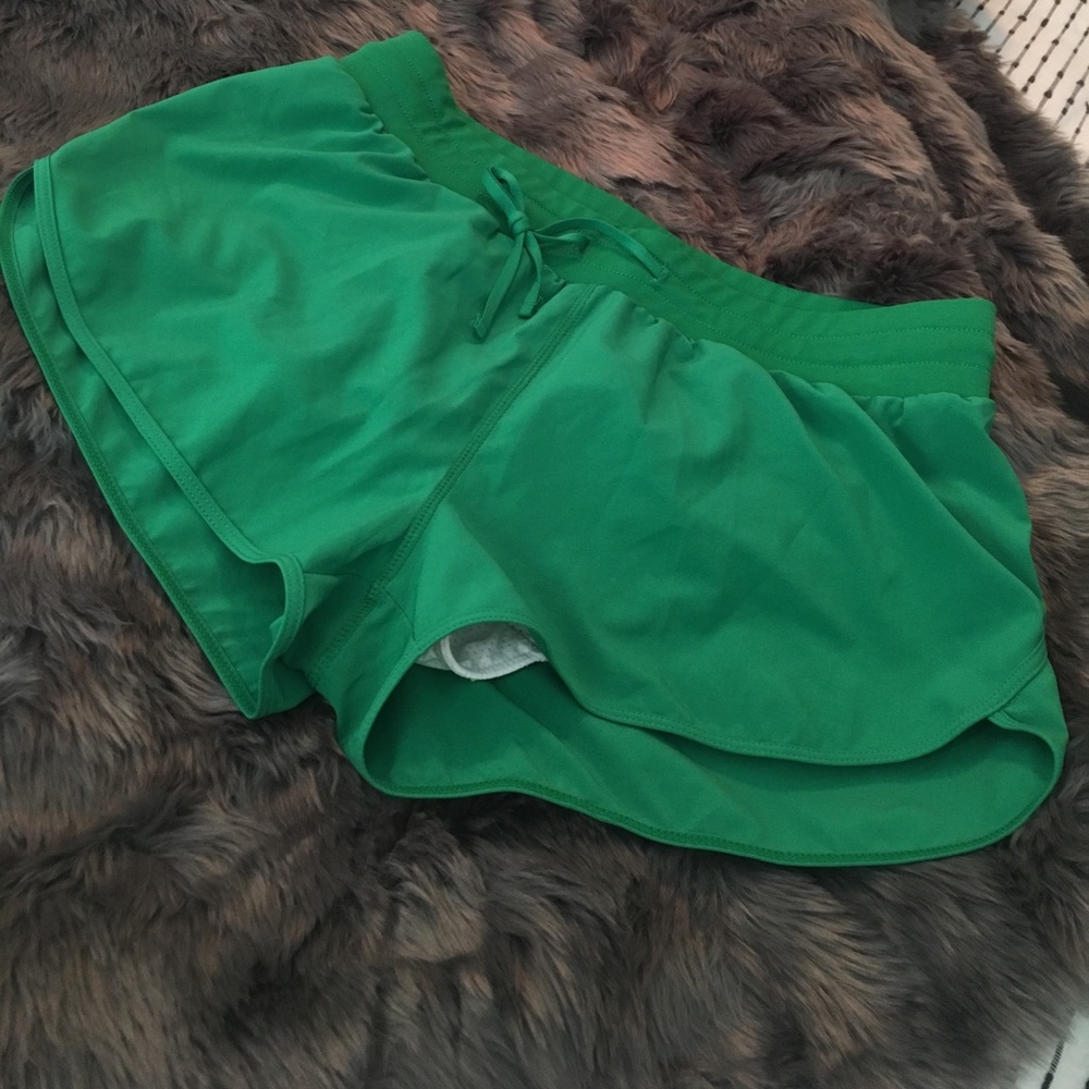 Green Fabletics brand running shorts
