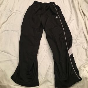 Boys pants that are black with a grey stripe