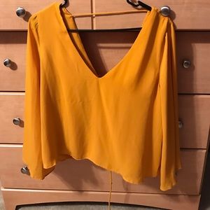 Mustard blouse with trumpet sleeve and laceup back