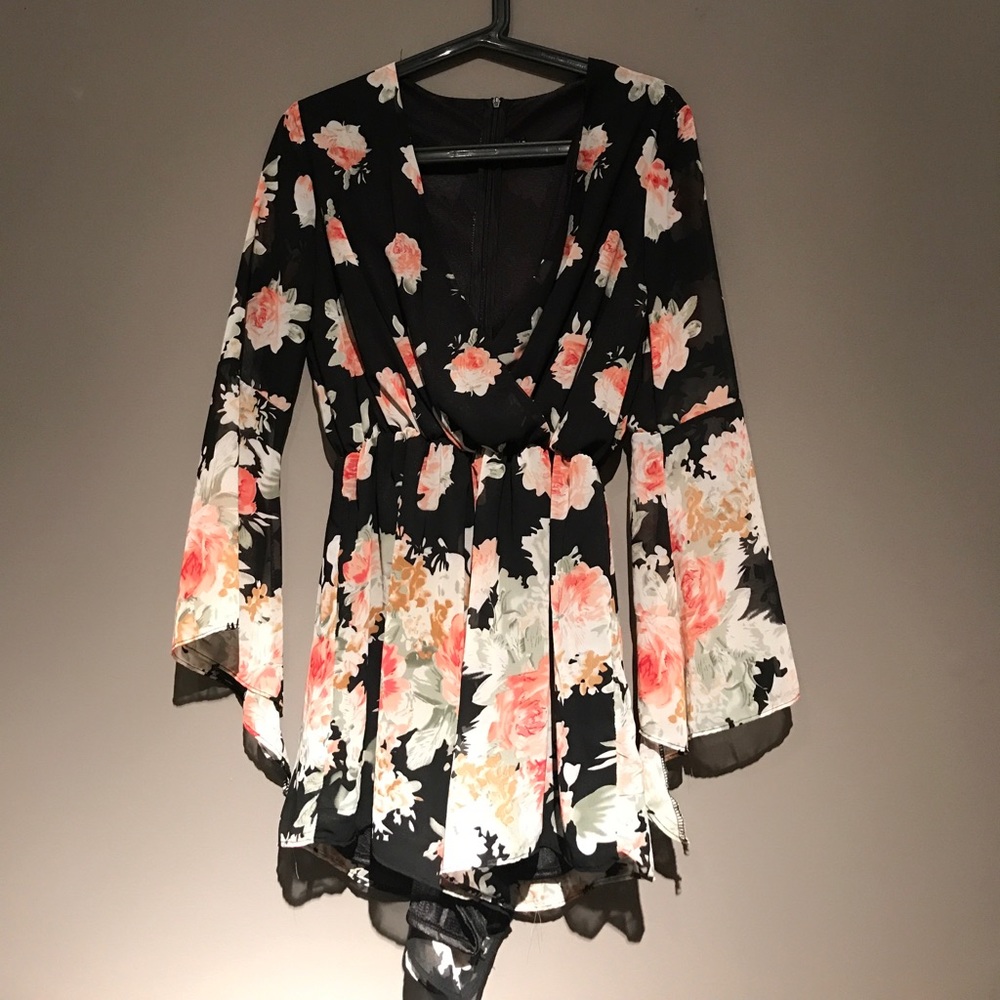 Beautiful black V-cut romper with floral pattern