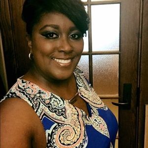 Blue sleeveless peep hole dress with gold accent.