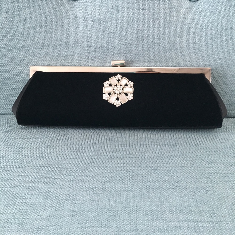Black velvet clutch with brooch.