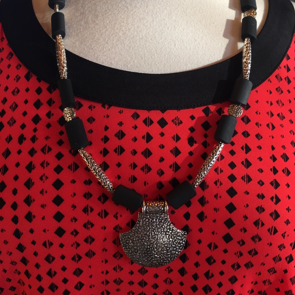Red and black flowing tank top w/ black necklace