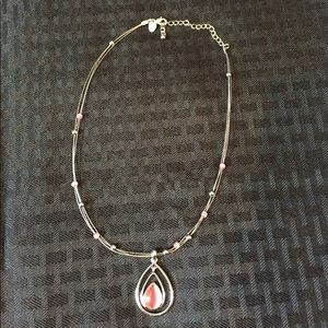 Silver wire necklace with pink stones and pendant.