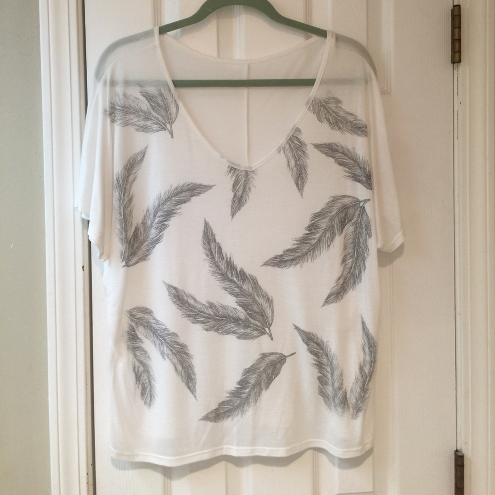 White shirt with feathers.