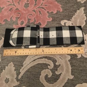 Plaid belt with buckle in front and elastic back.
