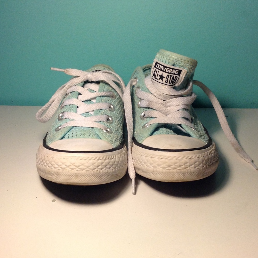 Light blue converse low tops with holes.