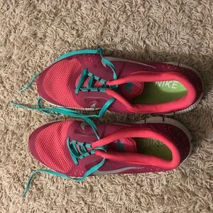 Pink and teal Nike shoes