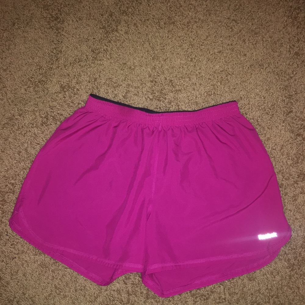 Pink reebok running shorts with built-in spandex