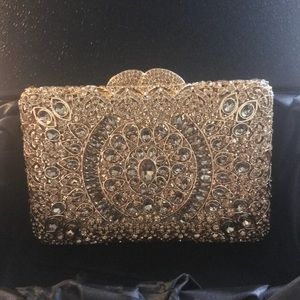 Gold clutch comes in original box.