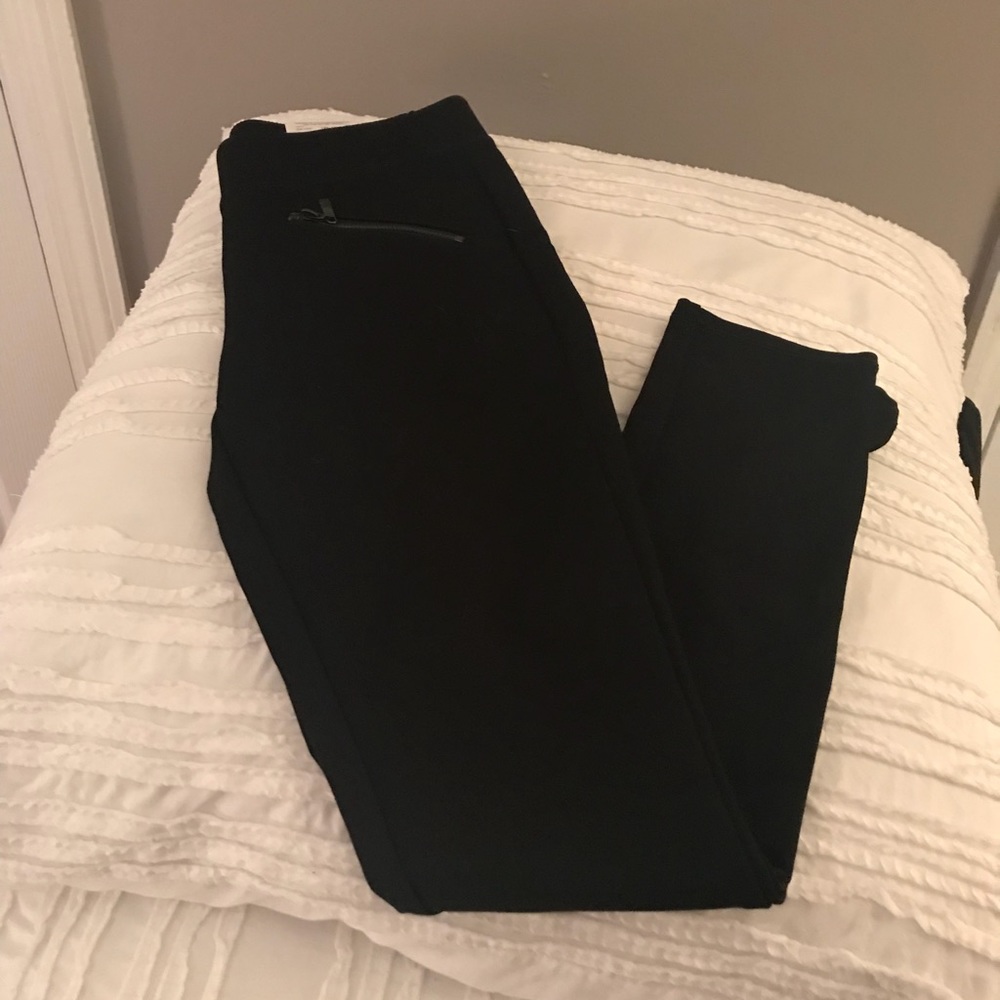 Black leggings with zippers in front.