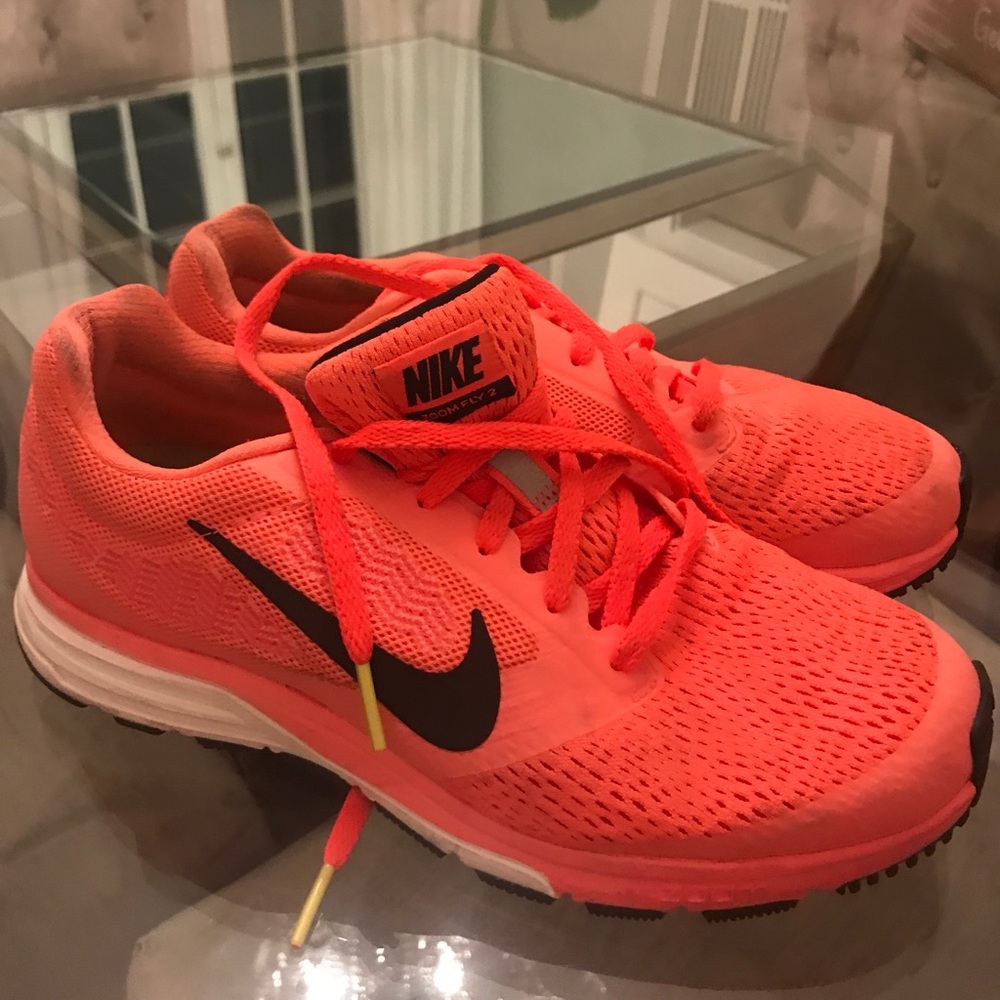 Neon orange Nike running shoes