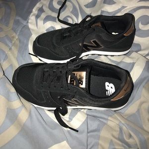 Black and gold suede new balance shoe