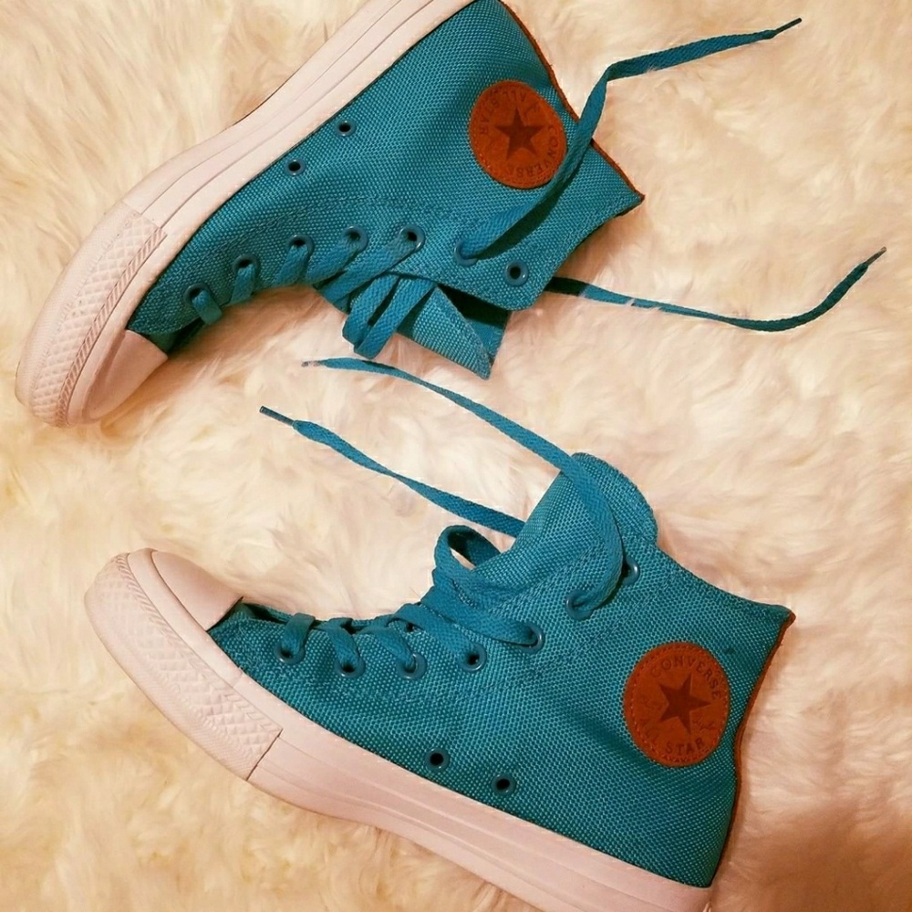 Canvas Teal Converse. Tan Leather logo