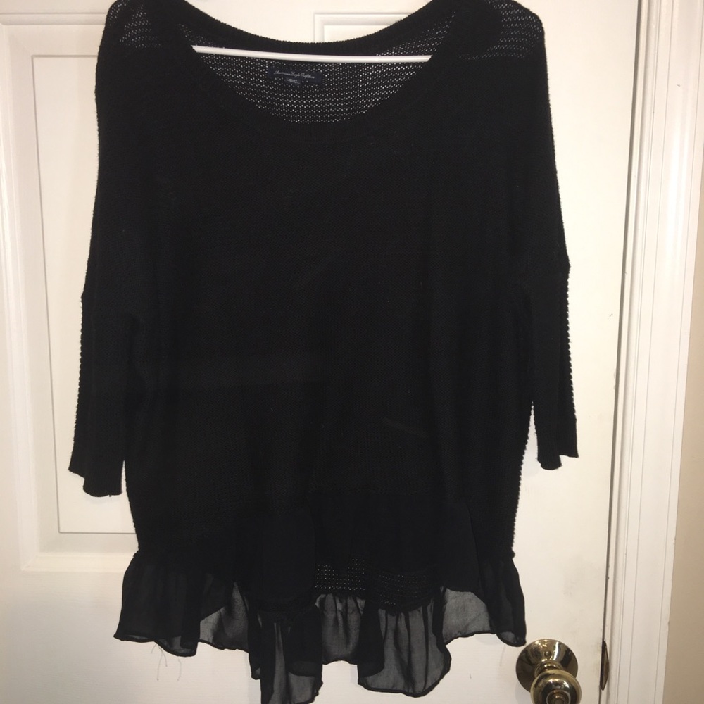 Black knit sweater with silk ruffles