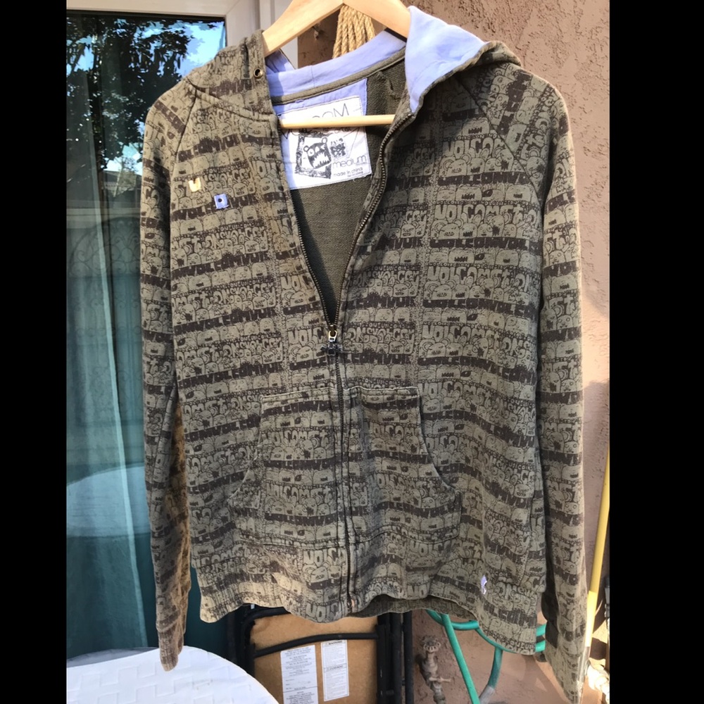 Volcom green zip up jacket with bear pattern.