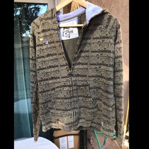 Volcom green zip up jacket with bear pattern.