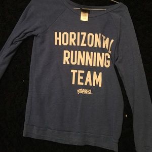 A blue long sleeve with a pitch perfect reference