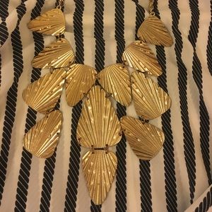 Gold feathered gold necklace.