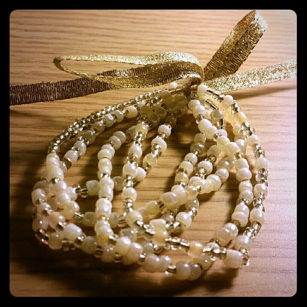 Gold and white beaded bracelets (5)