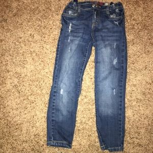 Child’s blue jeans with rips