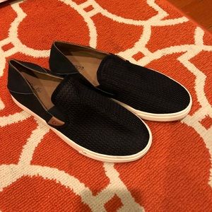 Olukai black slip ons with collapsible heel