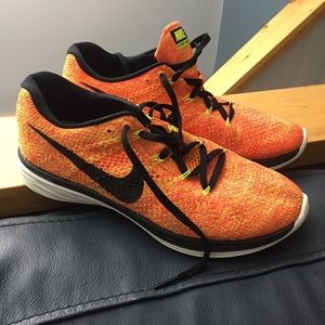 Orange and yellow Nike running shoes