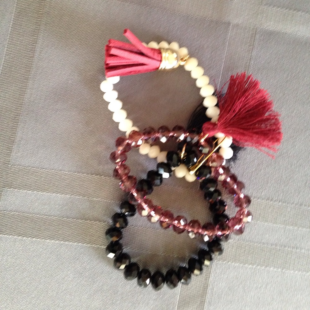 Cream, black and bronze bracelets. Sold as a set.