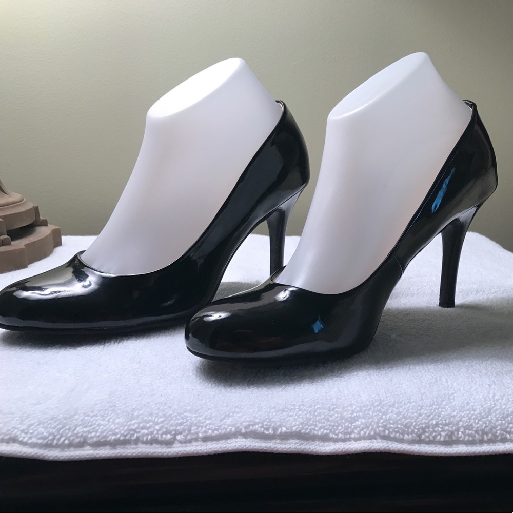 Nine West black patent leather high heel shoe.